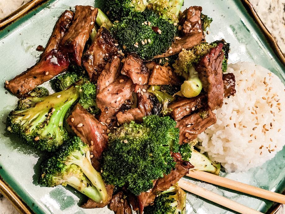 bowl of vegetables and steak over rice