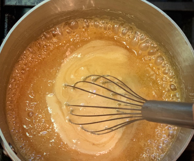 Adding cream to caramel sauce