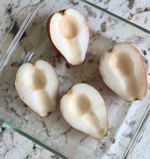 Pears halved in baking dish