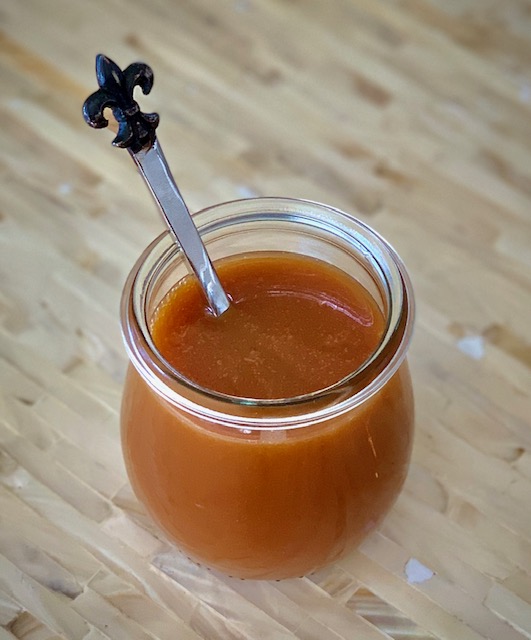 Salted Caramel Sauce in a jar with a spoon