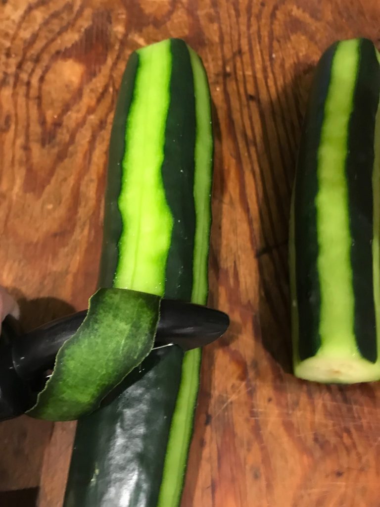 Peel cucumber in ribbon strips