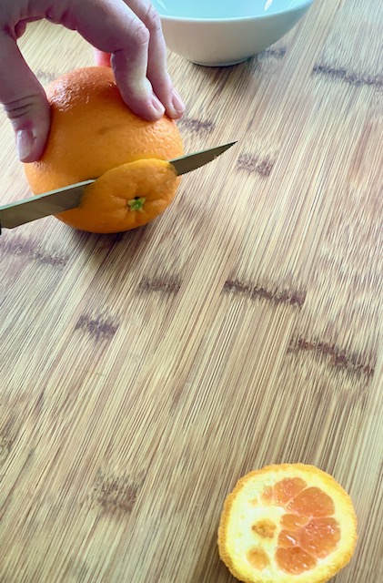 Cut off both ends of the orange