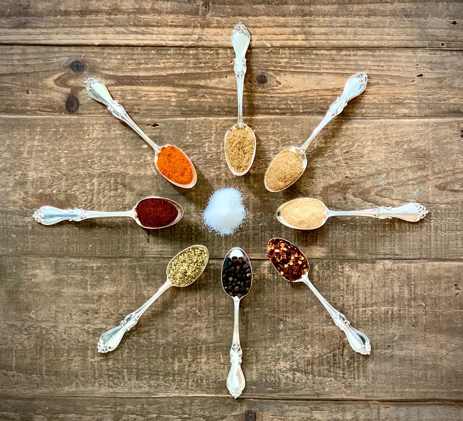 Potlatch Seasoning Ingredients on spoons on wooden board