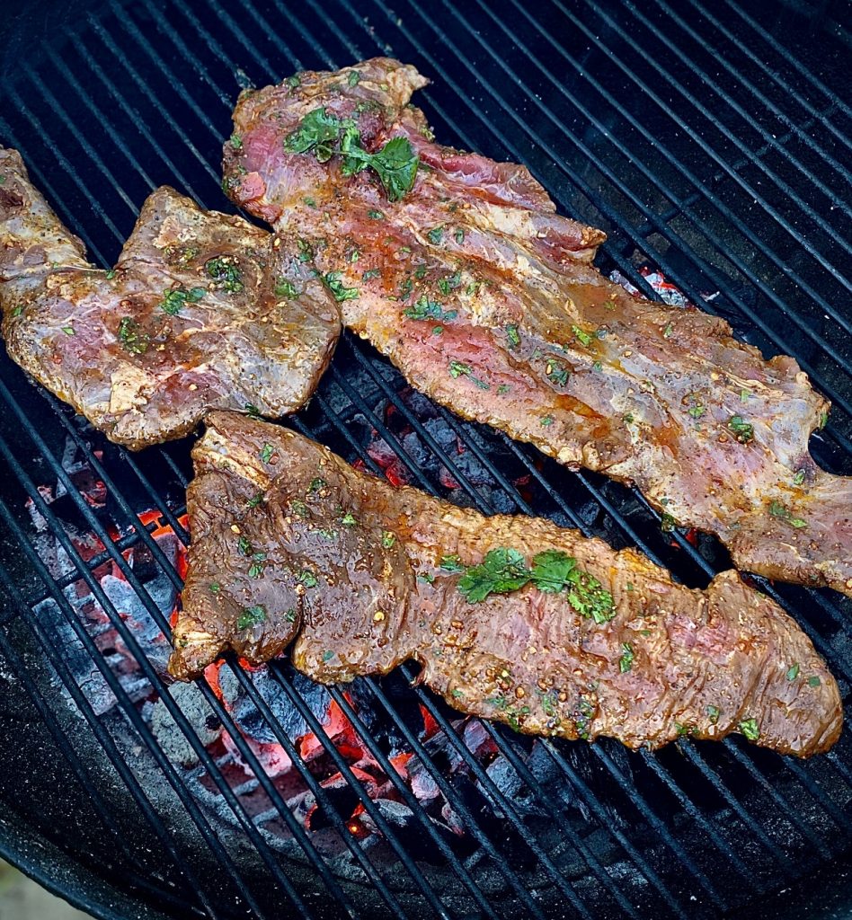 Grilling carne asada steak