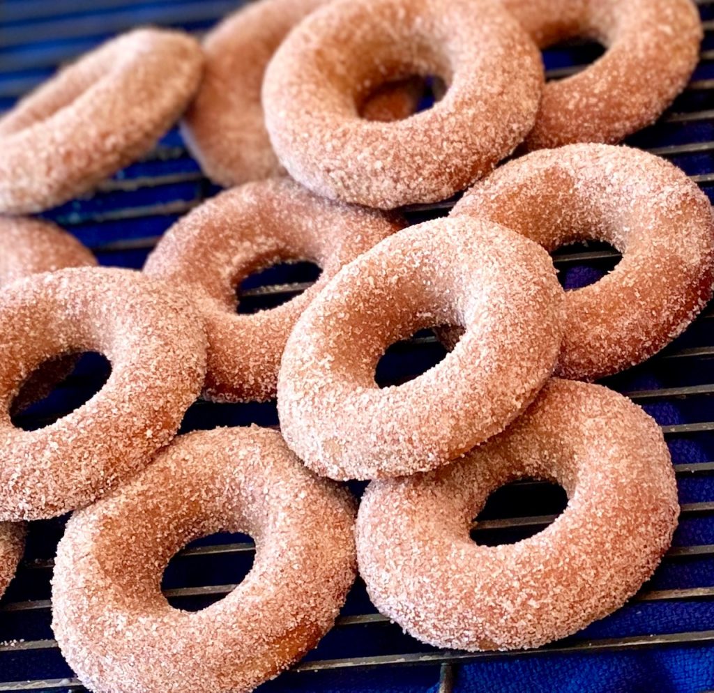 Baked Cinnamon Churro Donuts on a rack