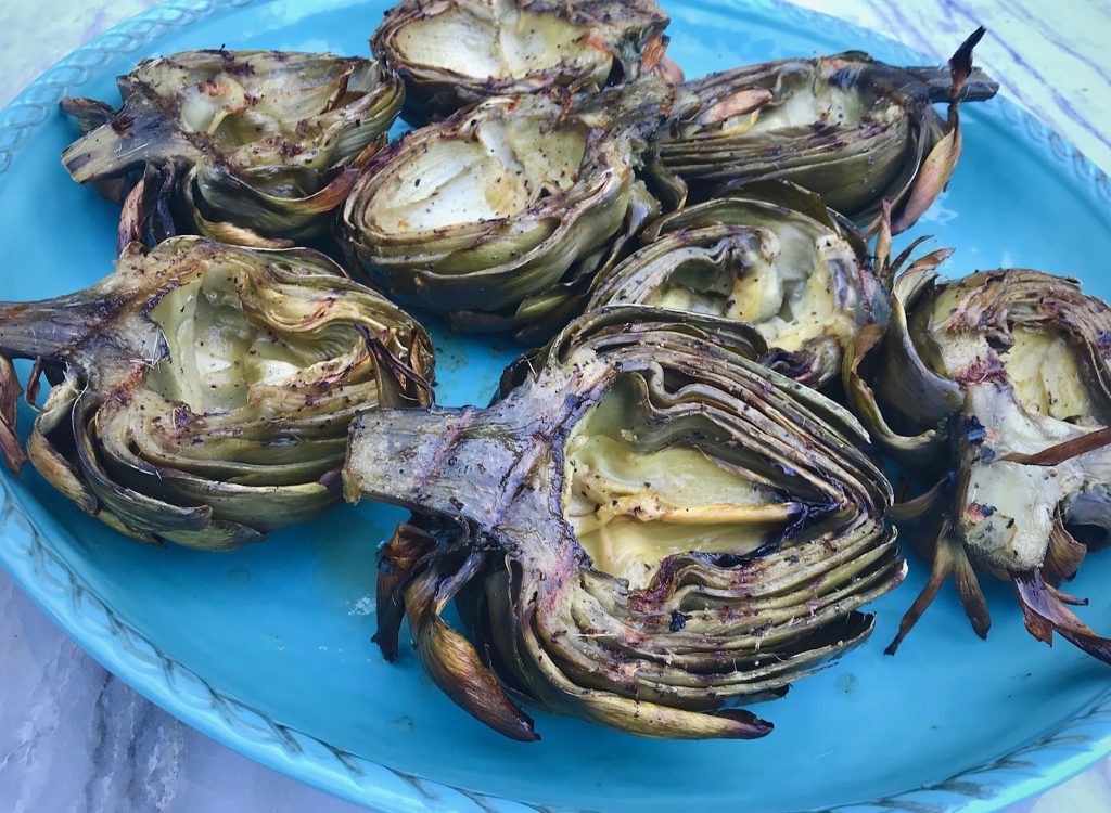 Grilled Artichokes on a blue platter