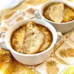 2 bowls of French Onion Soup with swiss cheese