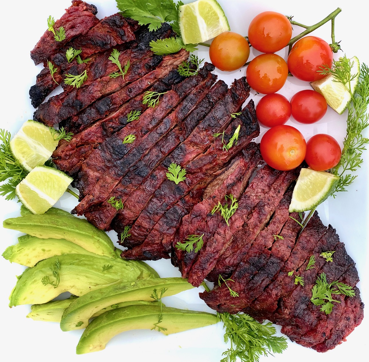 Carne Asada on a platter with vegetables