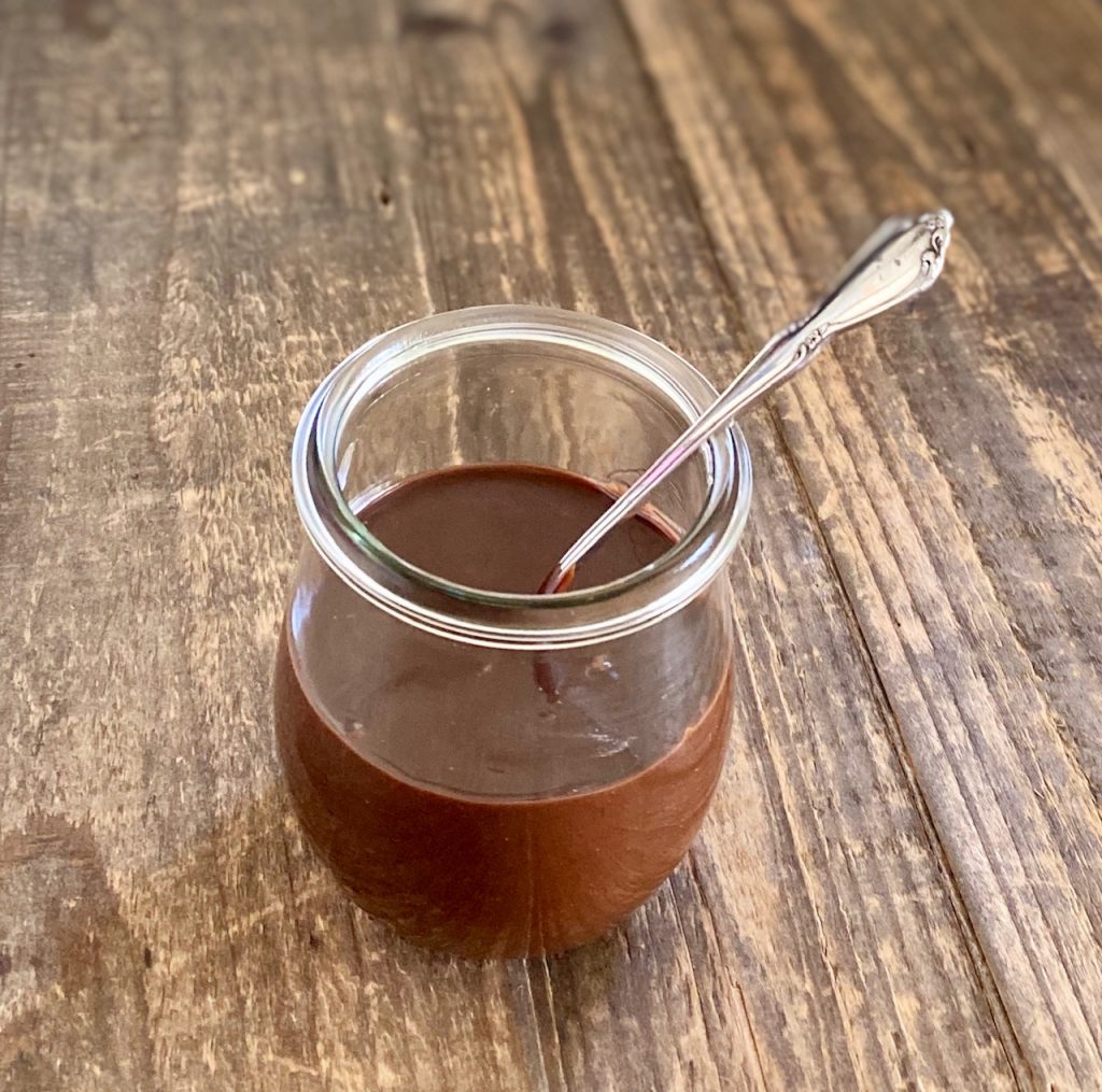 jar with spoon and chocolate sauce