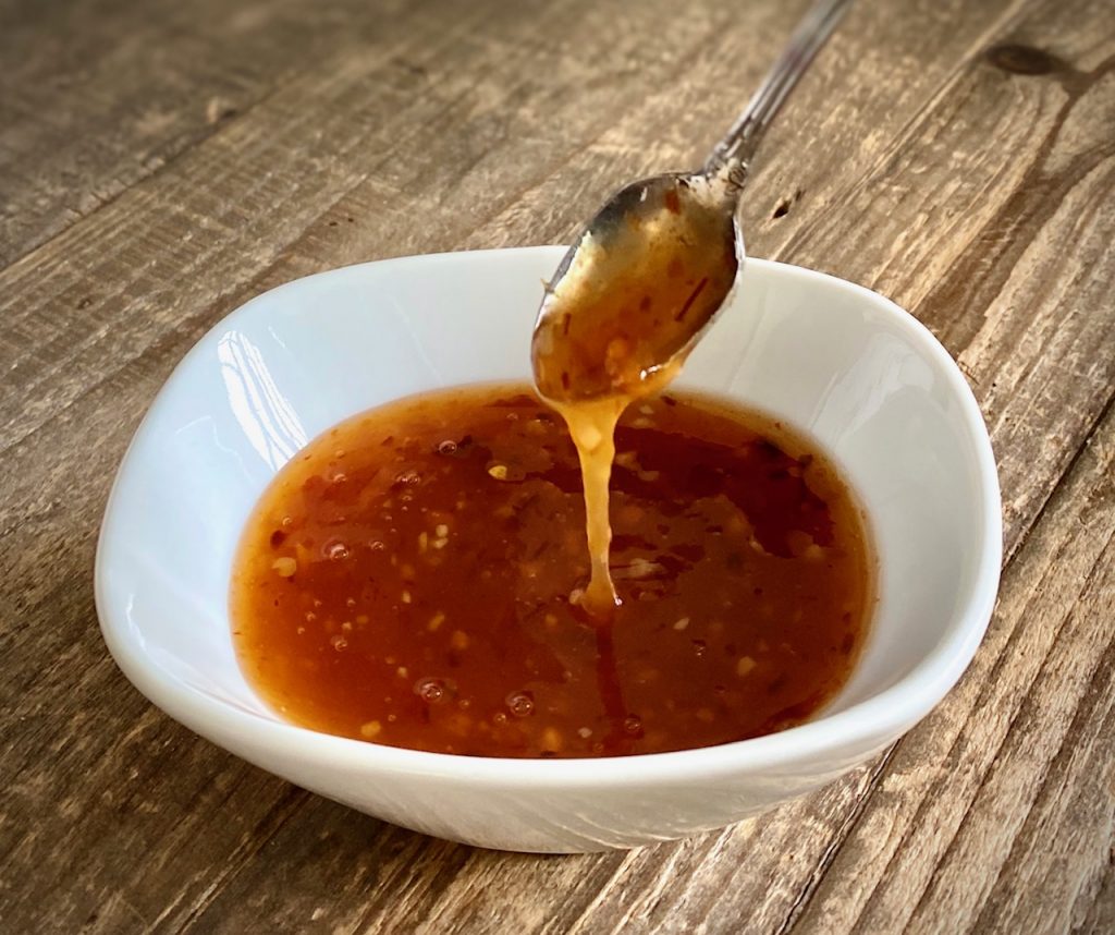 Sweet Chili Sauce in a bowl with a spoon