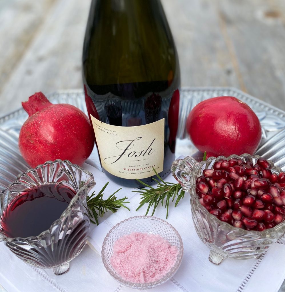 Ingredients for Pom Cocktails, juice, seeds, sugar and Prosecco