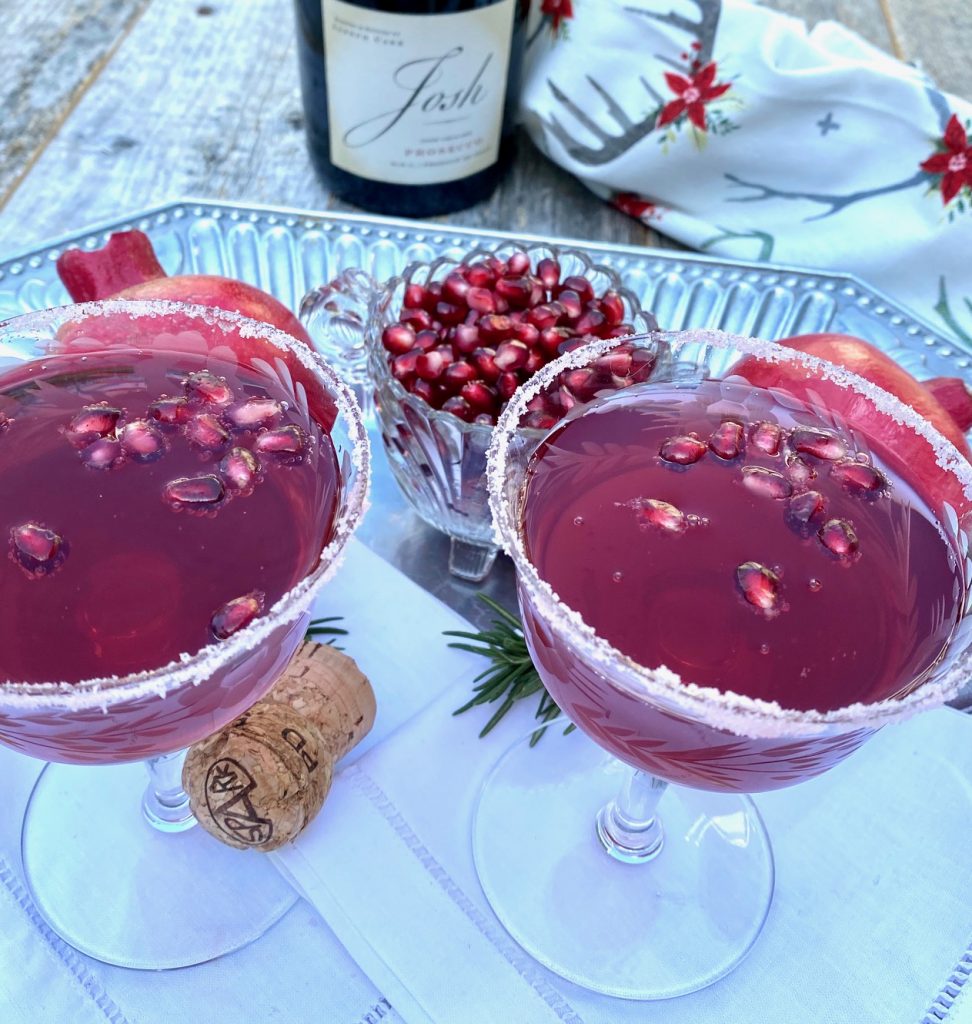 2 pomegranate cocktails and a bowl of pom seeds