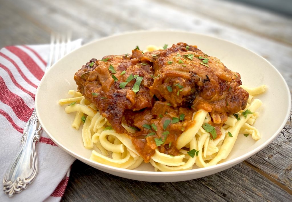 chicken paprikash in a bowl, over noodles