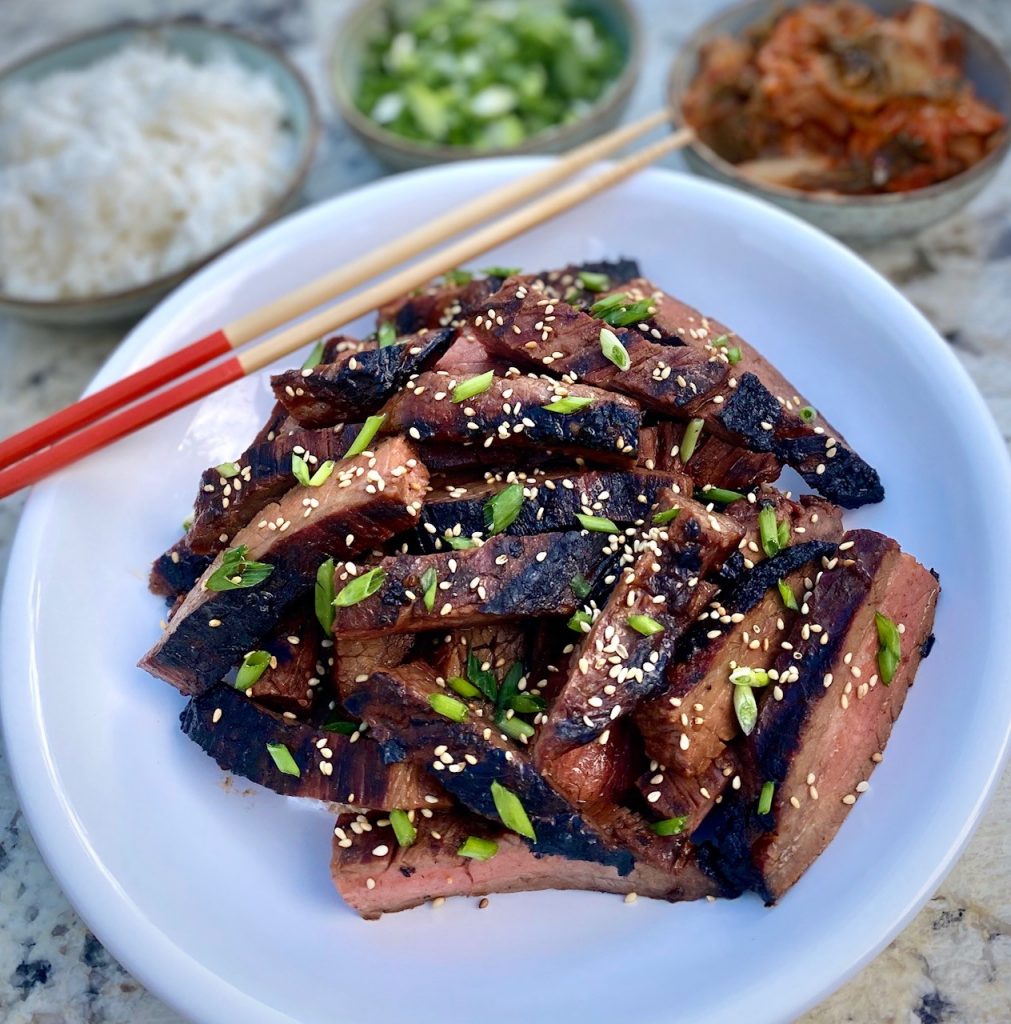 bowls of garnish and sliced asian beef 