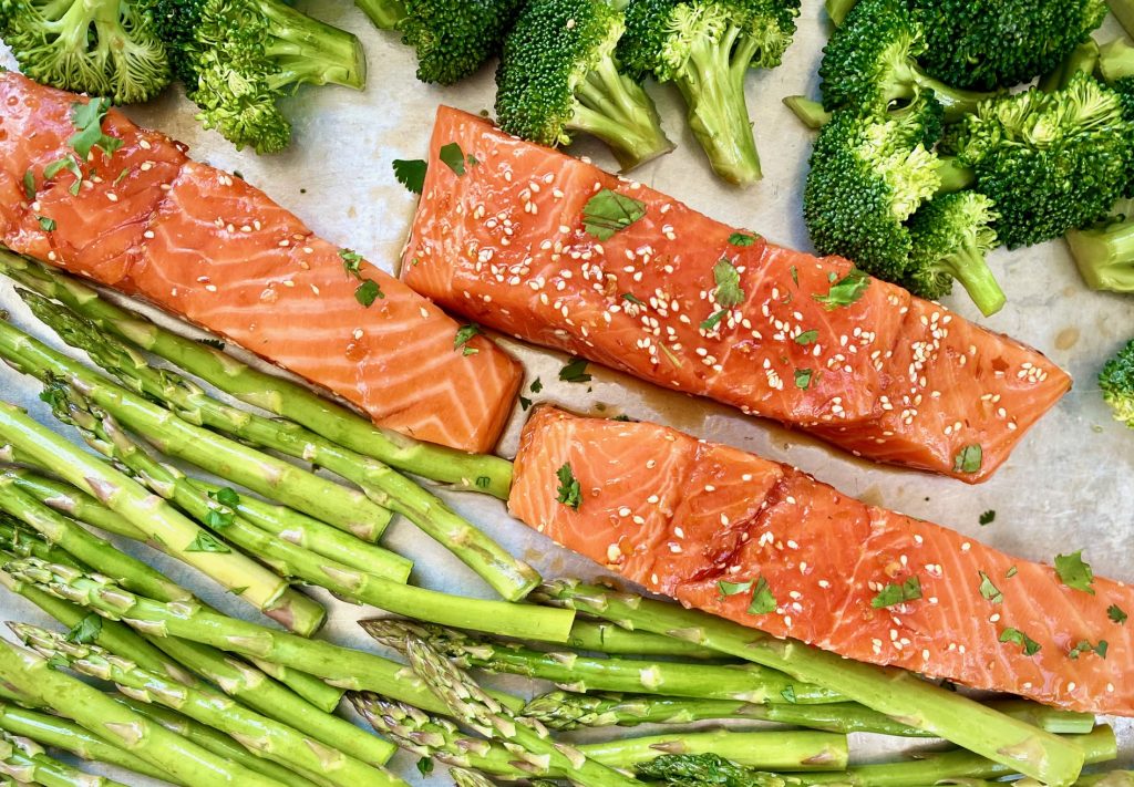 salmon, broccoli and asparagus on a silver pan