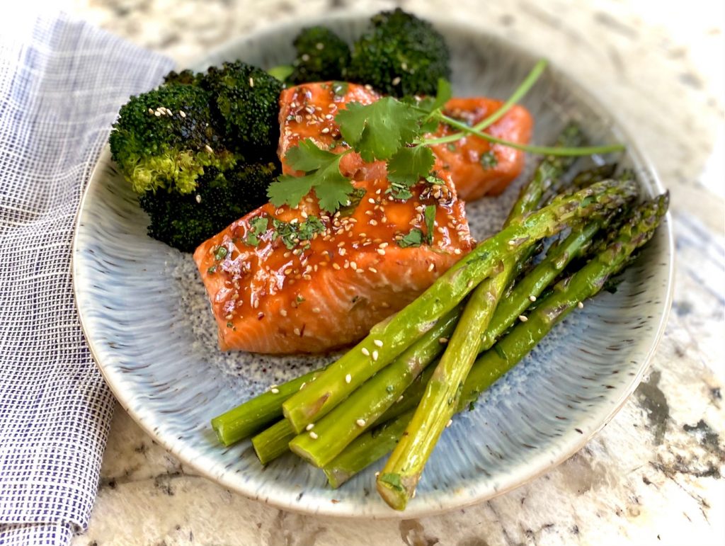 Salmon, asparagus and broccoli on blue plate