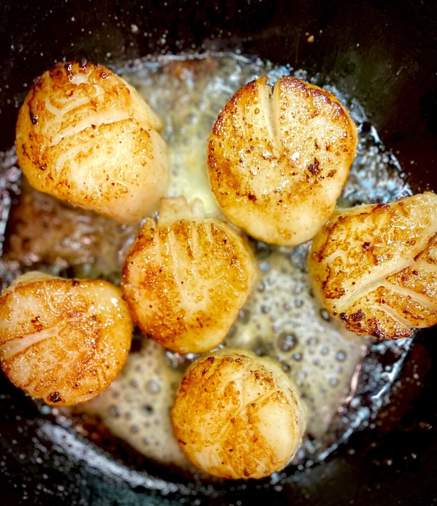 6 scallops in a cast iron pan