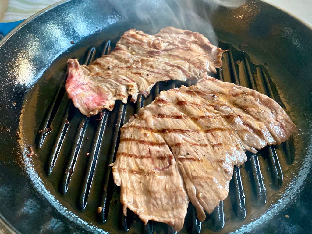 grilling 2 pieces of skirt steak in a grill pan