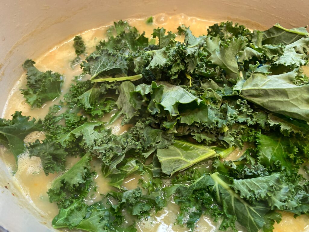 kale and soup ingredients in a pot