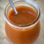 Salted Caramel Sauce in a jar with a spoon