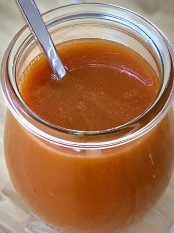 Salted Caramel Sauce in a jar with a spoon