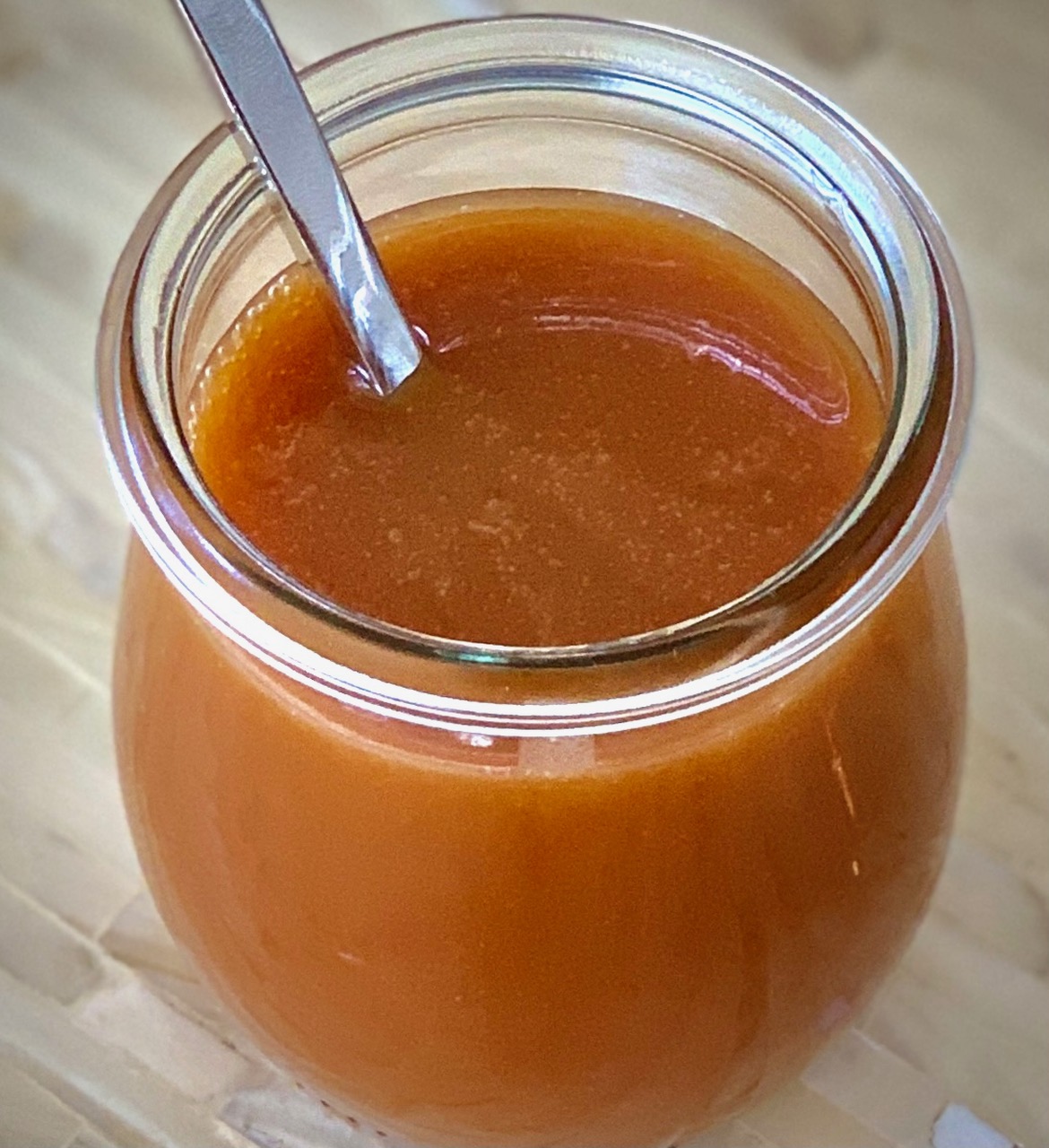 Salted Caramel Sauce in a jar with a spoon