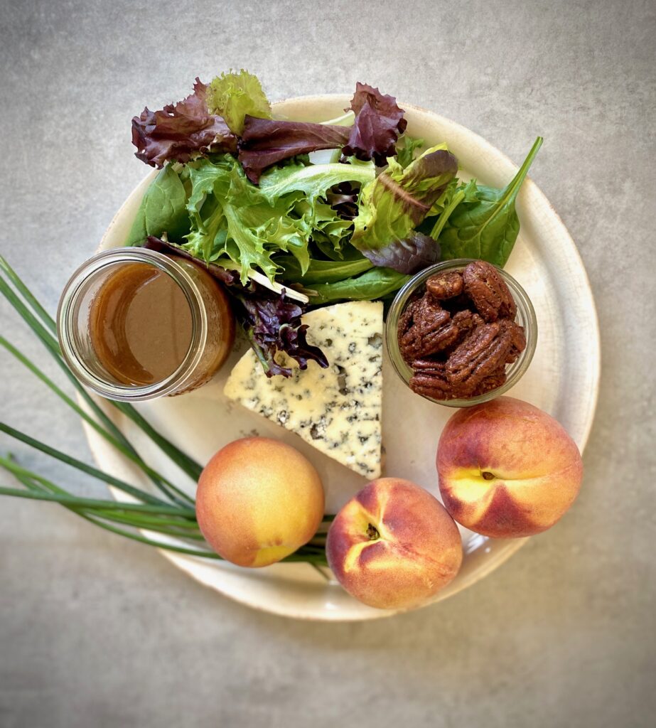 ingredients for peach salad on a white plate