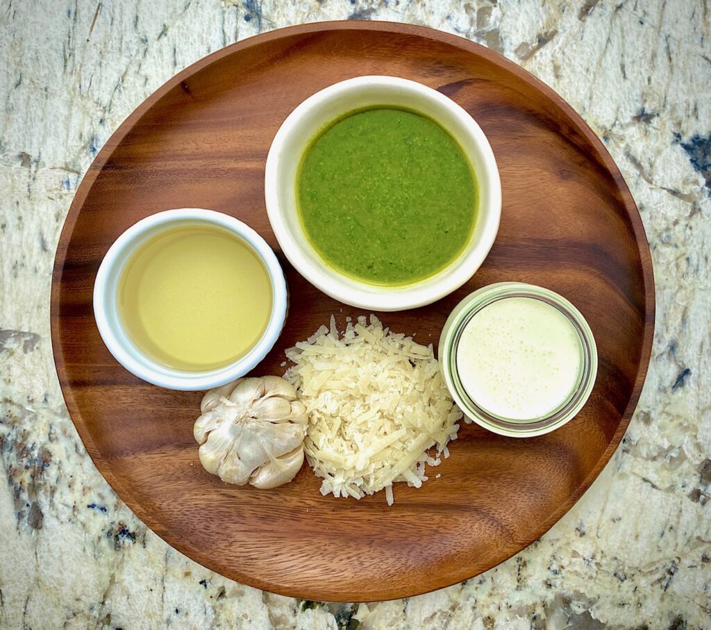 ingredients in bowls: wine, parmesan, garlic, cream, pesto