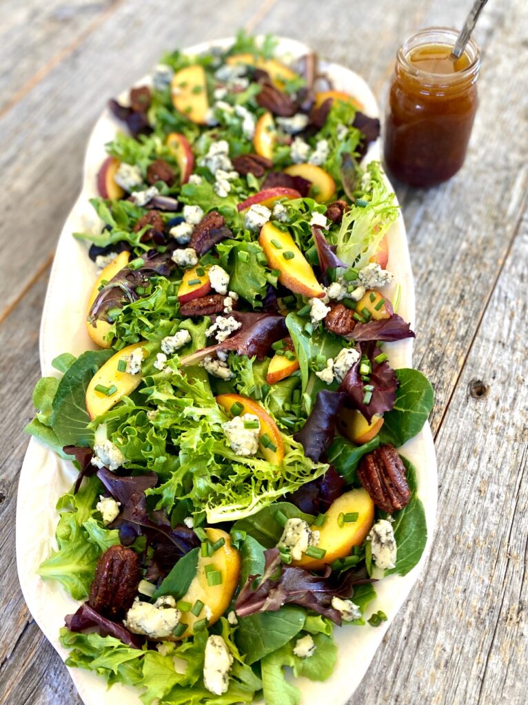 platter of peach salad with jar of dressing