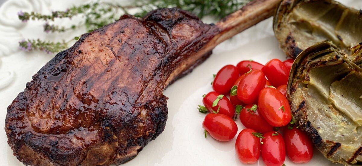 Grilled steak with rosemary and tomatoes