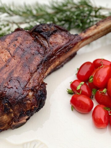 Grilled steak with rosemary and tomatoes