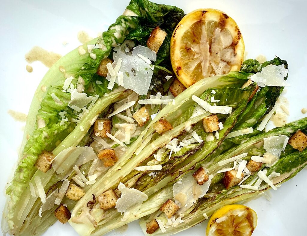 a grilled caesar salad on a platter