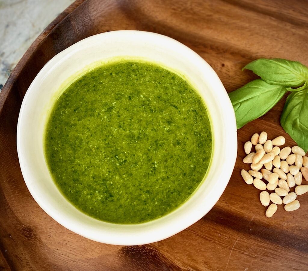 a white bowl of basil pesto