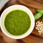 a white bowl of basil pesto