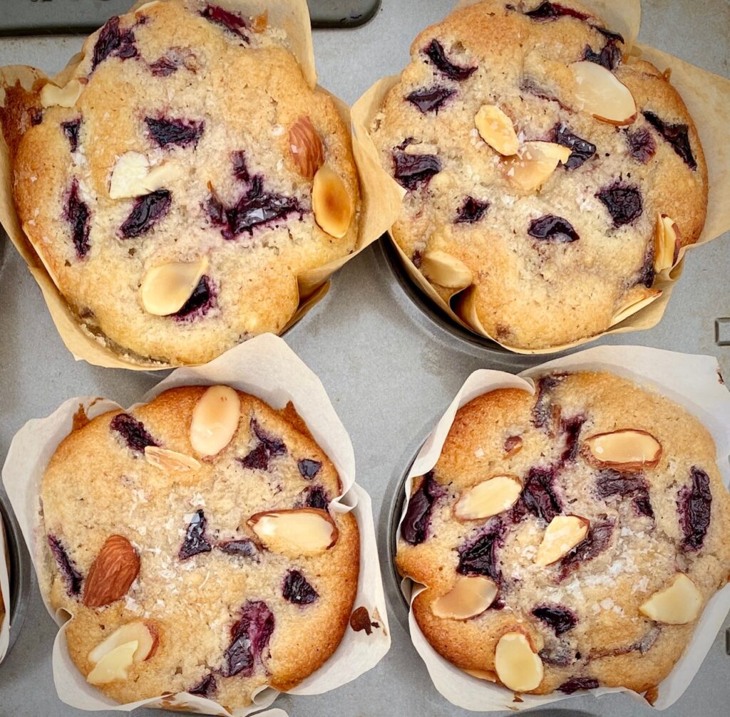 4 cherry muffins in a pan