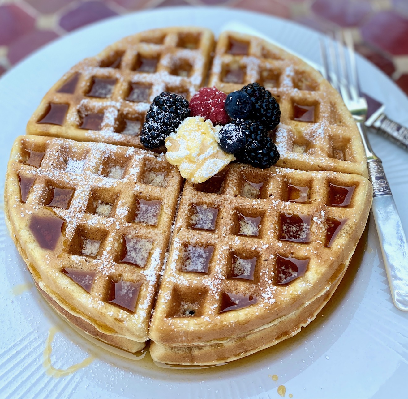 waffle on plate on red table