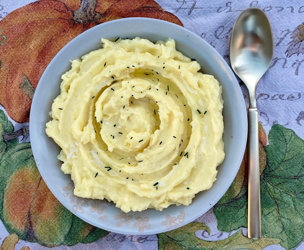 Mashed potatoes in bowl with spoon