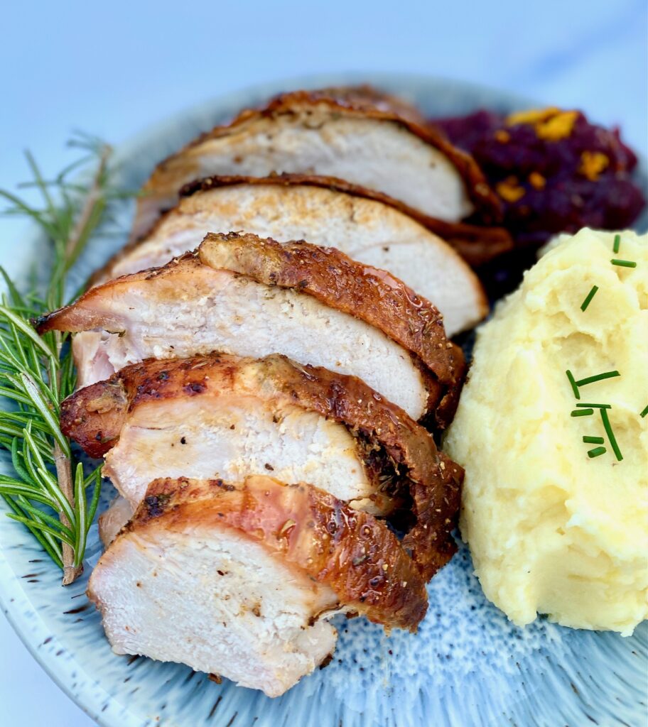 turkey sliced on a plate with side dishes