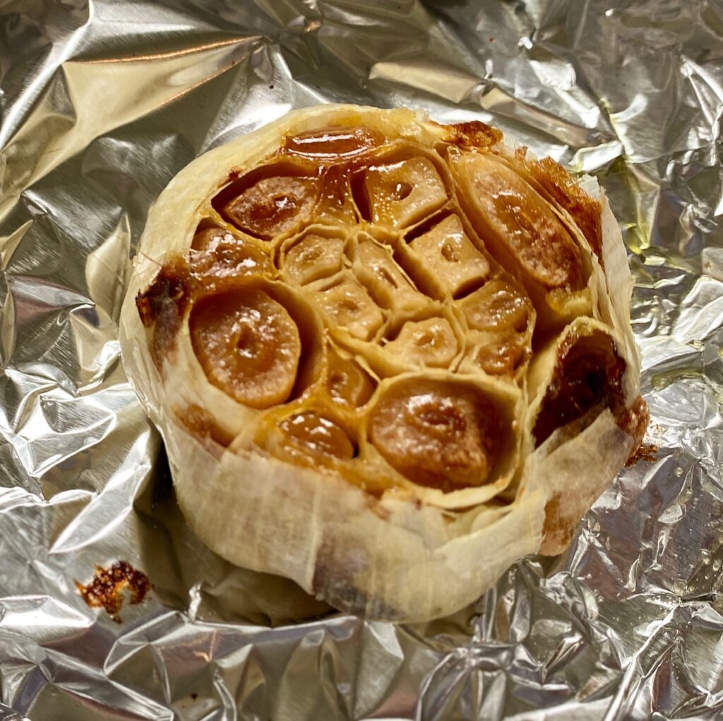 roasted garlic bulb on a piece of foil
