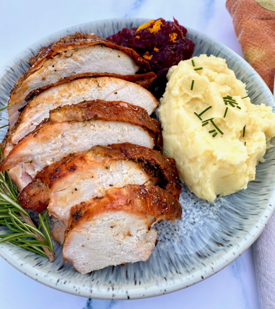 turkey, mashed potatoes and cranberry sauce dinner on a plate