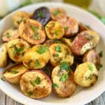 bowl of oven roasted potatoes with herbs