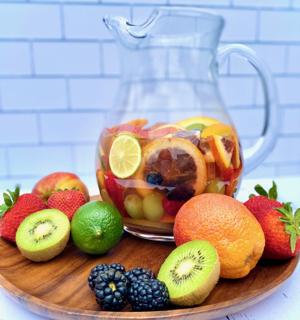 Pitcher of sangria with fruit on platter