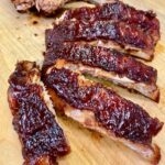 oven baked ribs on a cutting board