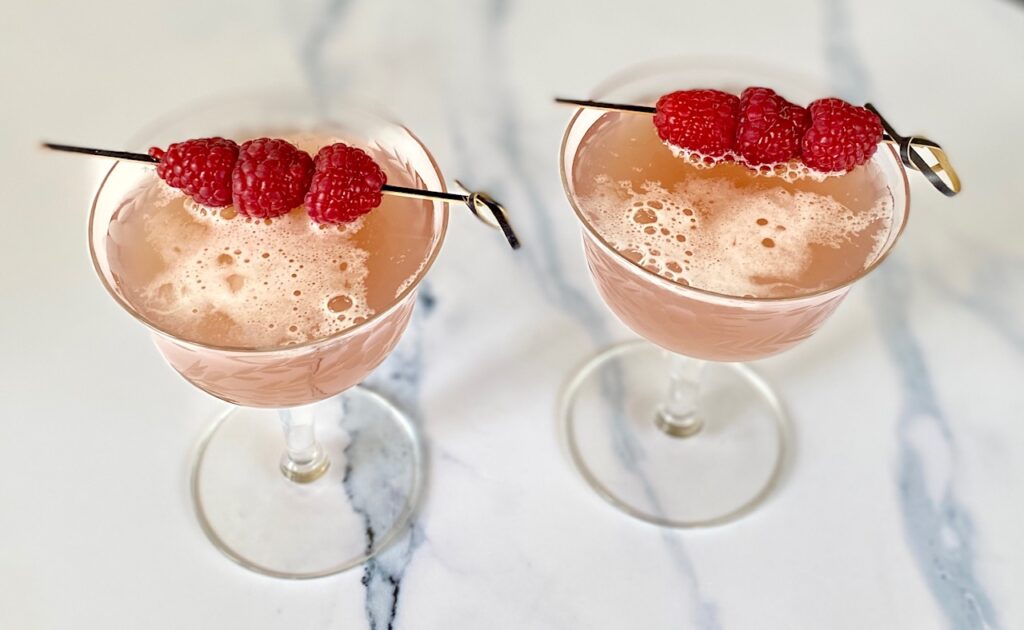 2 frothy cocktails with garnish