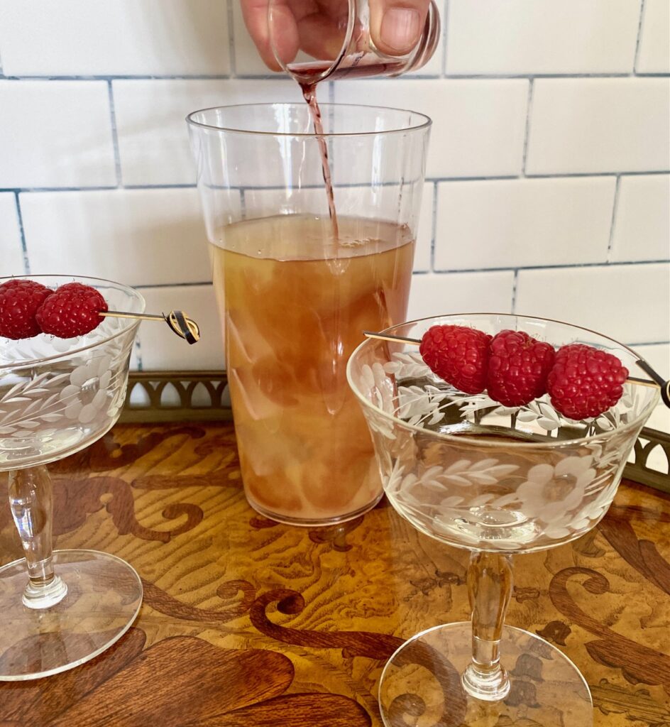 Pouring Chambord into shaker with glasses