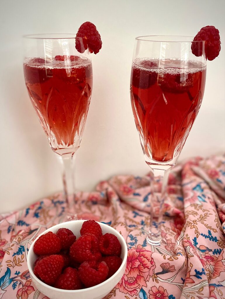 2 Kir Royale drinks and raspberries
