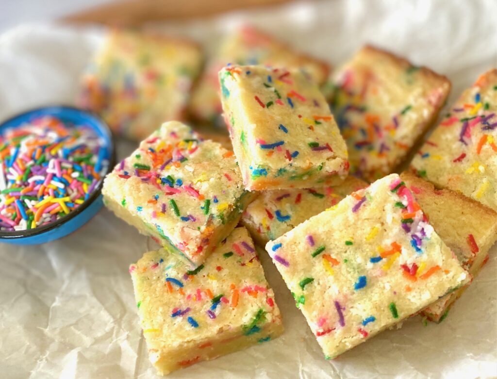 bowl of sprinkles and tray of cookie bars