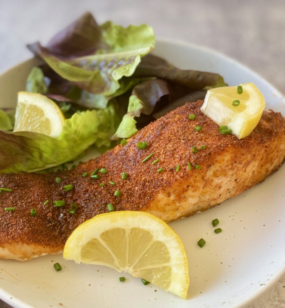 cooked salmon with lemon on plate