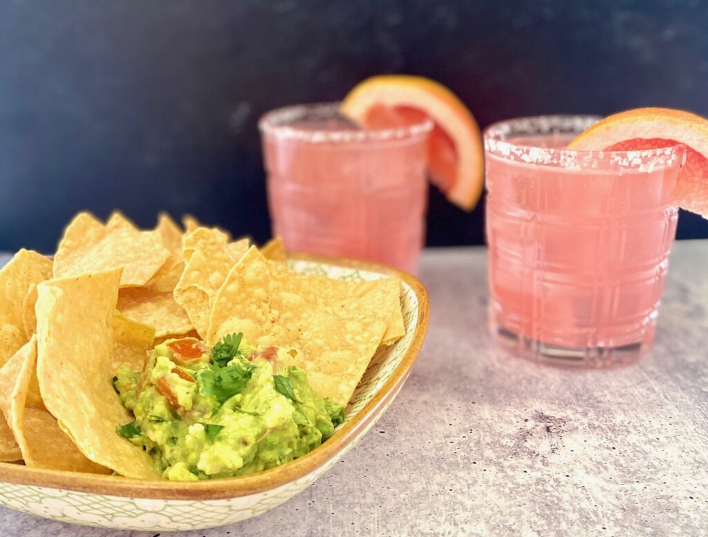 chips, guac and 2 grapefruit tequila drinks