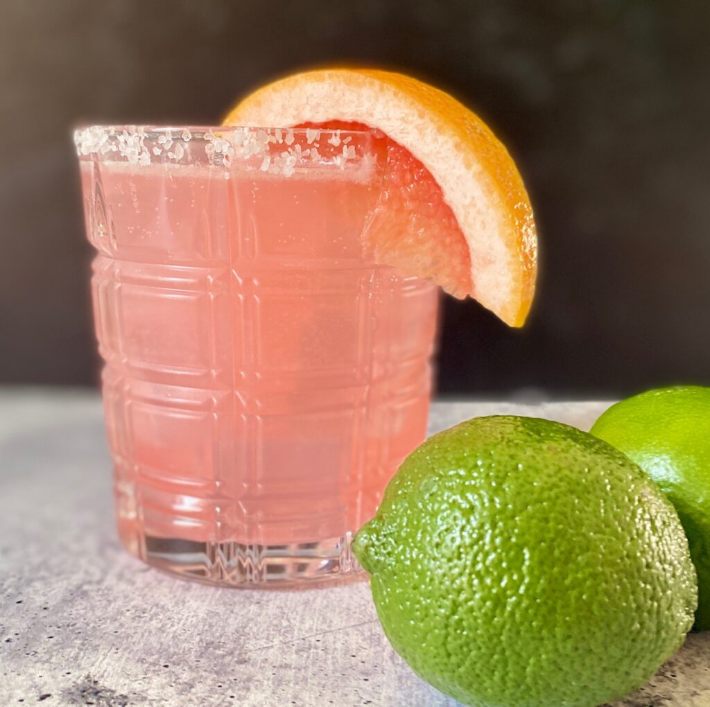 one paloma cocktail with a lime